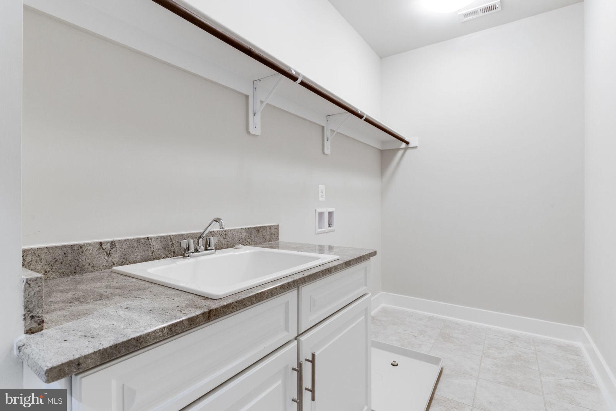 307 Cabin Road Southeast Vienna, VA 22180 - Photo 14 of 25 a bathroom with a granite countertop sink and white cabinets