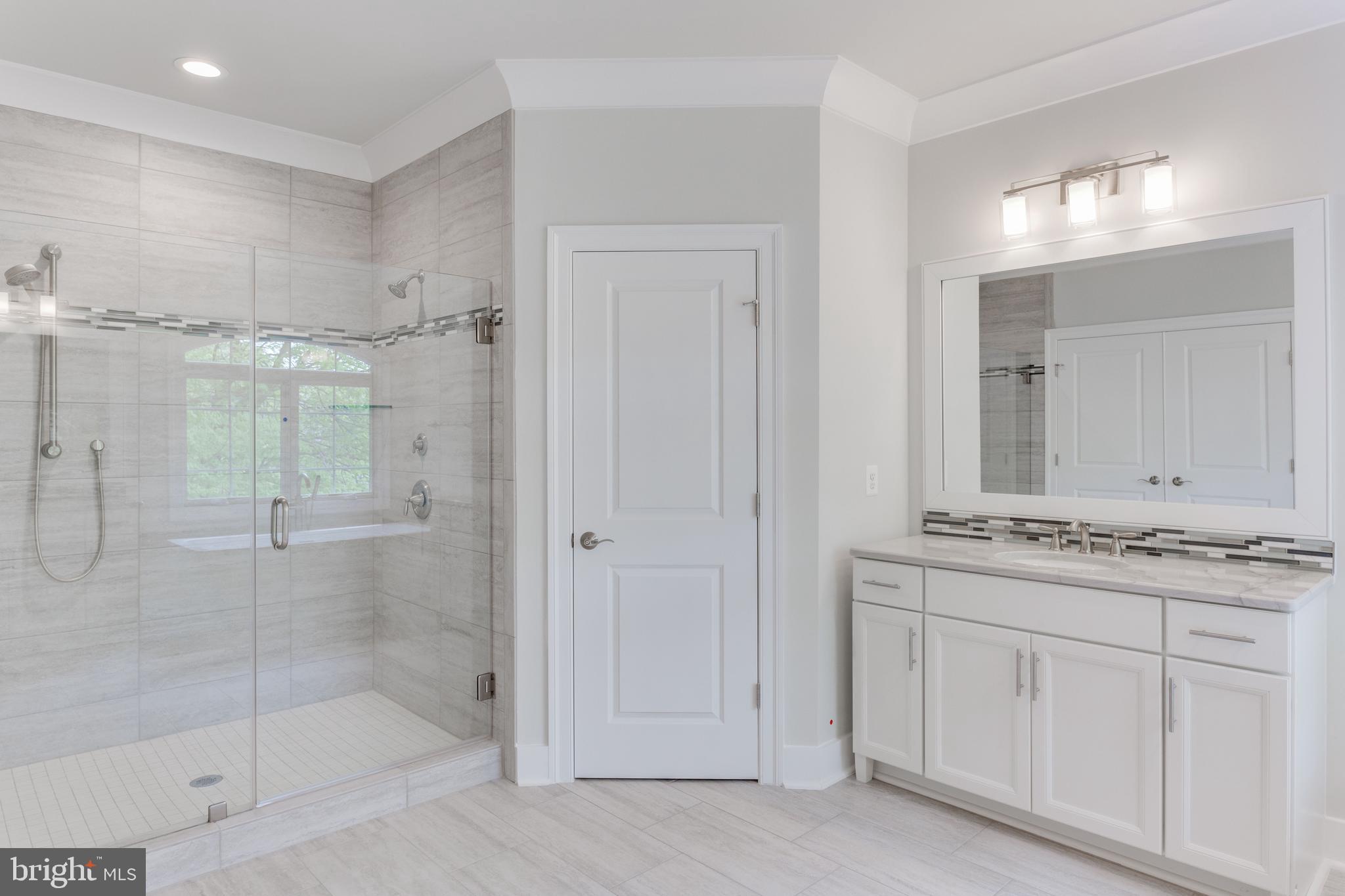 307 Cabin Road Southeast Vienna, VA 22180 - Photo 16 of 25 a bathroom with a shower sink and mirror