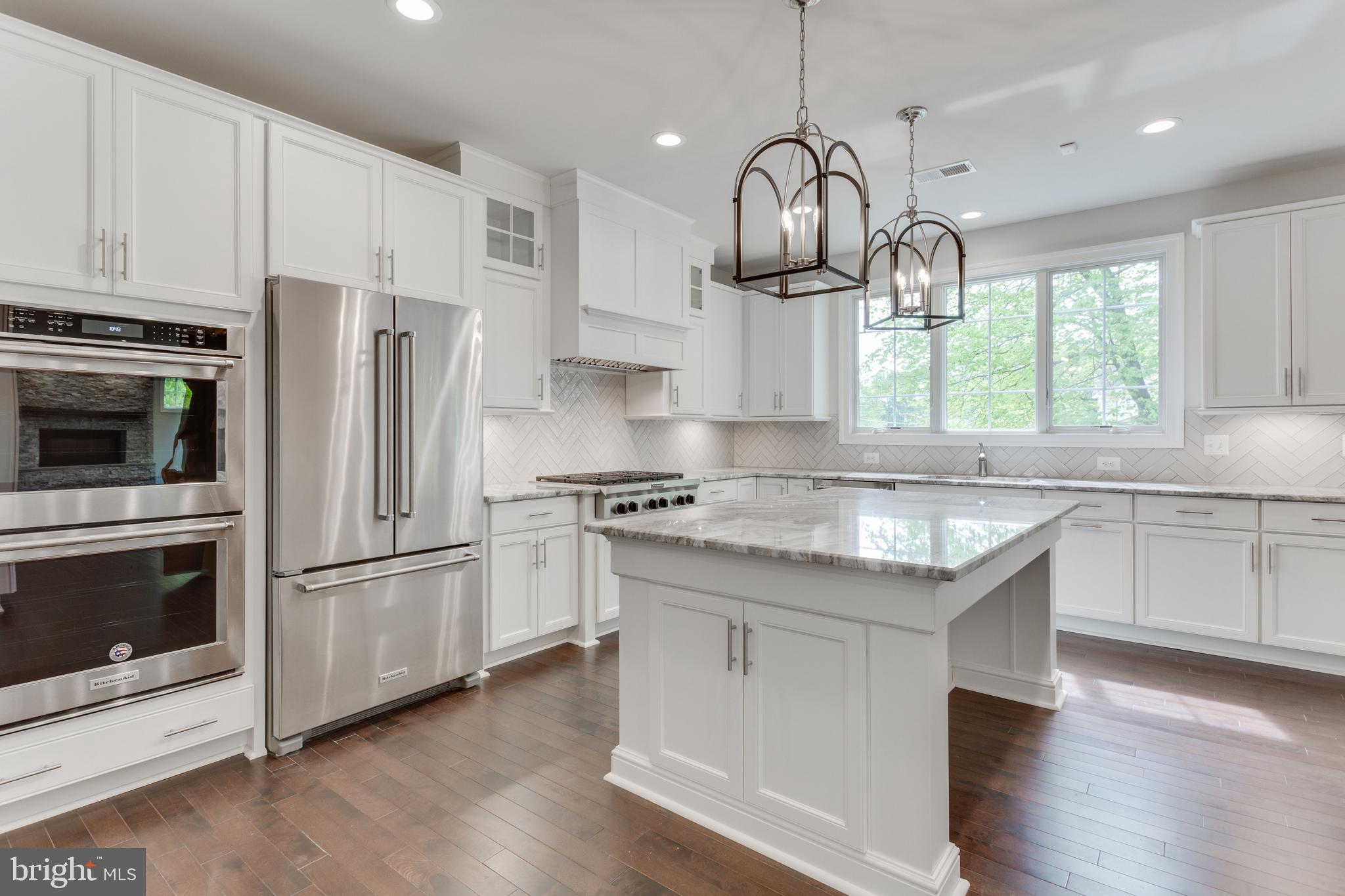 307 Cabin Road Southeast Vienna, VA 22180 - Photo 9 of 25 a kitchen with stainless steel appliances granite countertop a sink a stove a refrigerator and a window with wooden floors