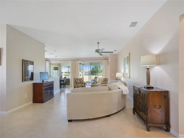 a living room with furniture a fireplace and a view of kitchen