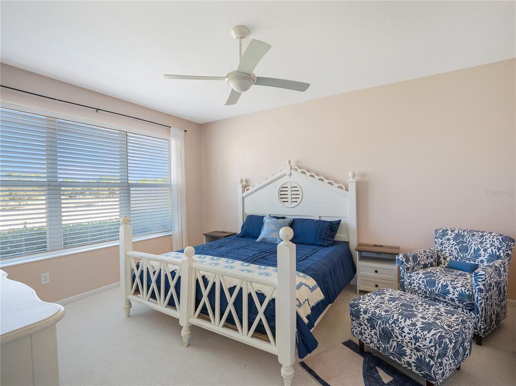 6776 Southwest 91st Circle Ocala, FL 34481 - Photo 18 of 60 a bedroom with furniture and a large window