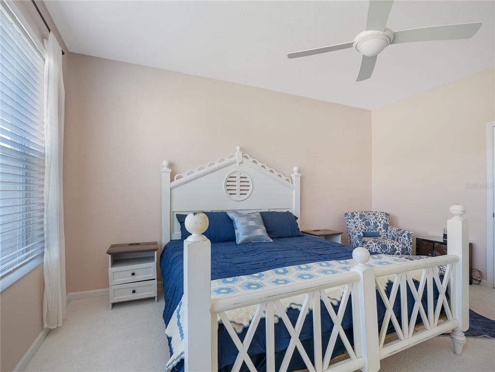 6776 Southwest 91st Circle Ocala, FL 34481 - Photo 19 of 60 a bedroom with a bed and ceiling fan