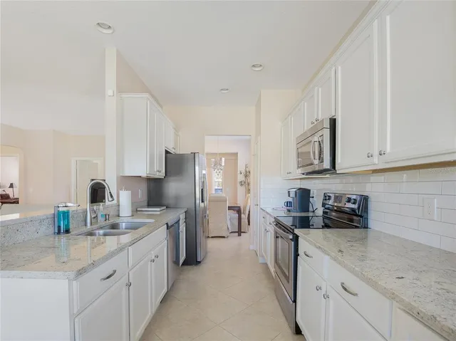 a kitchen with stainless steel appliances granite countertop sink microwave and cabinets