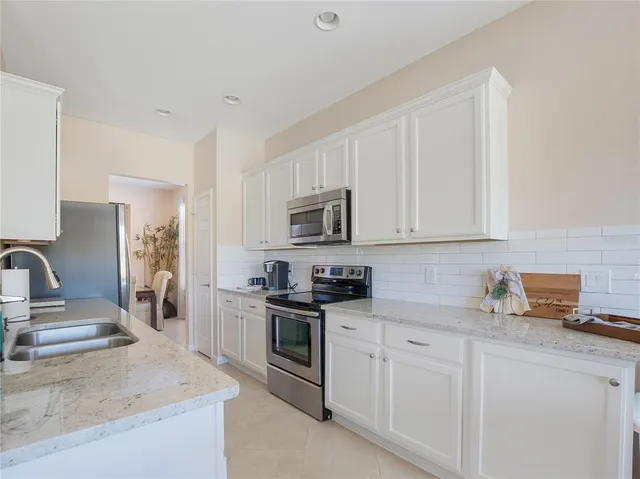 a kitchen with sink cabinets and stove