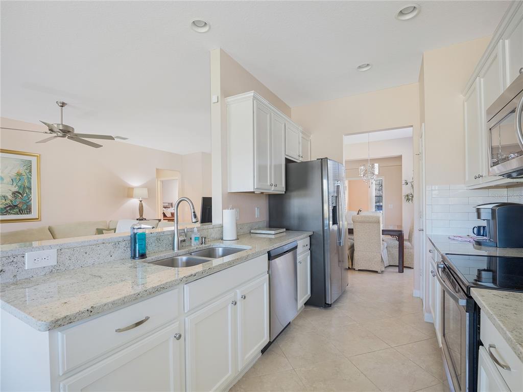 6776 Southwest 91st Circle Ocala, FL 34481 - Photo 28 of 60 a kitchen with a sink stove and refrigerator