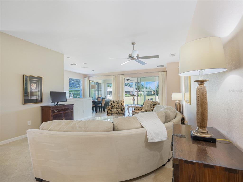 6776 Southwest 91st Circle Ocala, FL 34481 - Photo 29 of 60 a living room with furniture and a chandelier