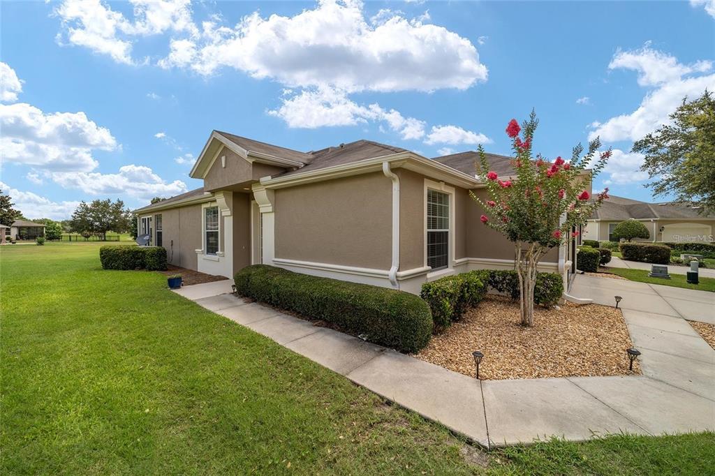6776 Southwest 91st Circle Ocala, FL 34481 - Photo 3 of 60 a front view of a house with garden
