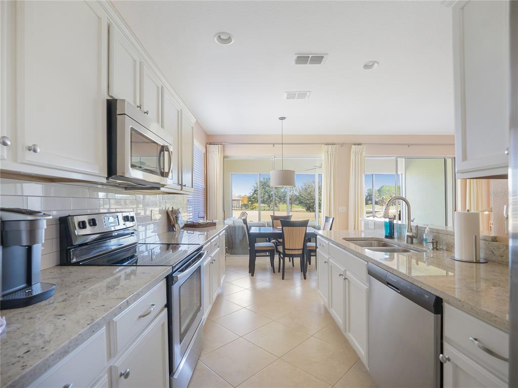 6776 Southwest 91st Circle Ocala, FL 34481 - Photo 33 of 60 a kitchen with sink cabinets and stove
