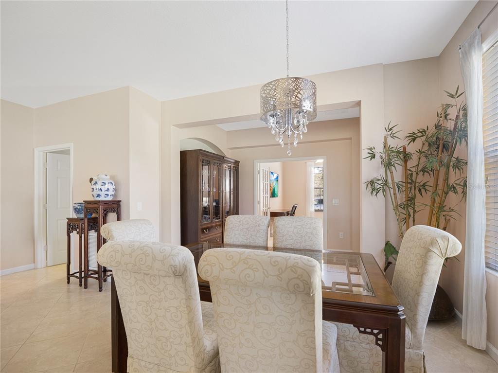 6776 Southwest 91st Circle Ocala, FL 34481 - Photo 34 of 60 a view of a dining room with furniture and chandelier