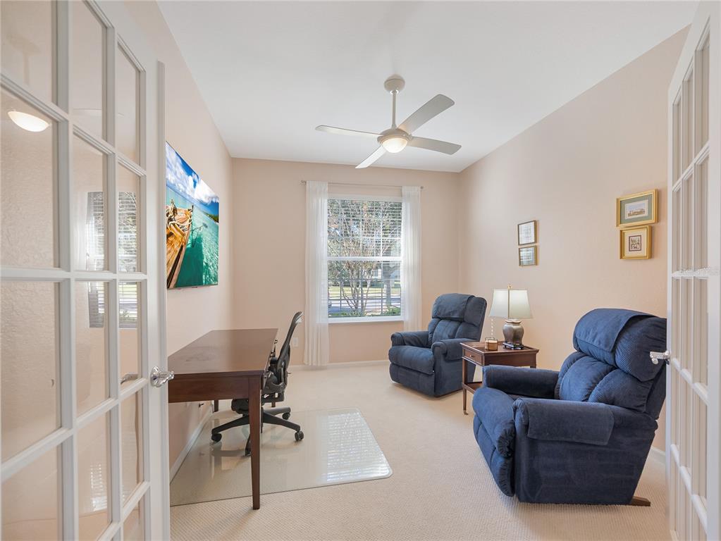 6776 Southwest 91st Circle Ocala, FL 34481 - Photo 35 of 60 a living room with furniture a ceiling fan and a window