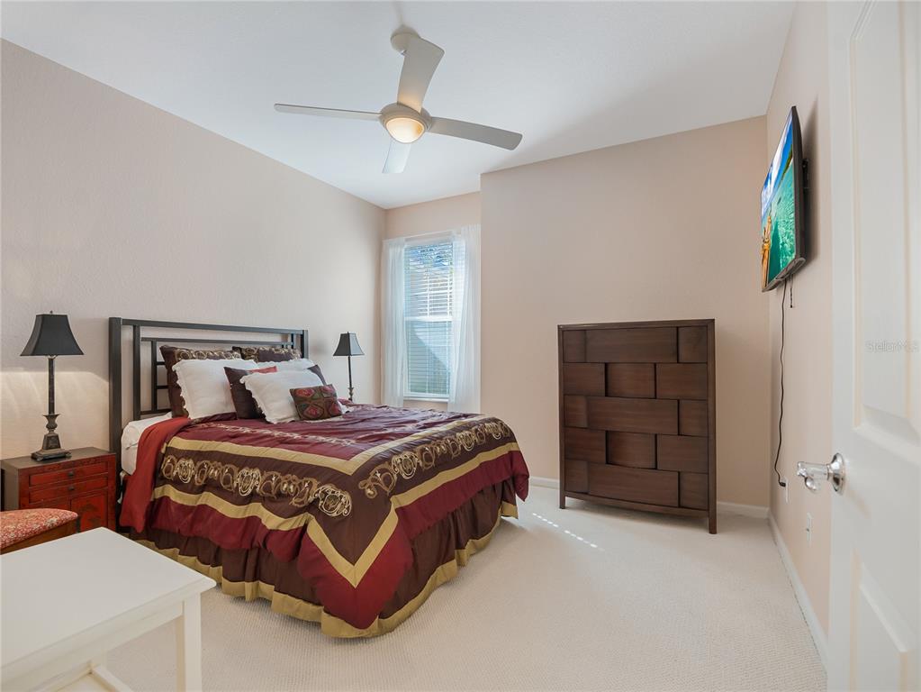 6776 Southwest 91st Circle Ocala, FL 34481 - Photo 45 of 60 a bedroom with a bed and a flat screen tv