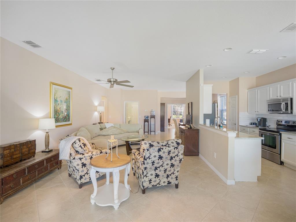 6776 Southwest 91st Circle Ocala, FL 34481 - Photo 49 of 60 a living room with furniture and a chandelier