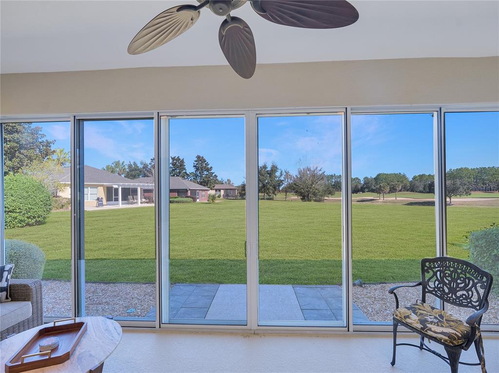 6776 Southwest 91st Circle Ocala, FL 34481 - Photo 51 of 60 a living room with a floor to ceiling window and floor to ceiling window