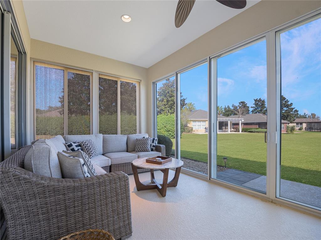 6776 Southwest 91st Circle Ocala, FL 34481 - Photo 54 of 60 a living room with couch and a floor to ceiling window