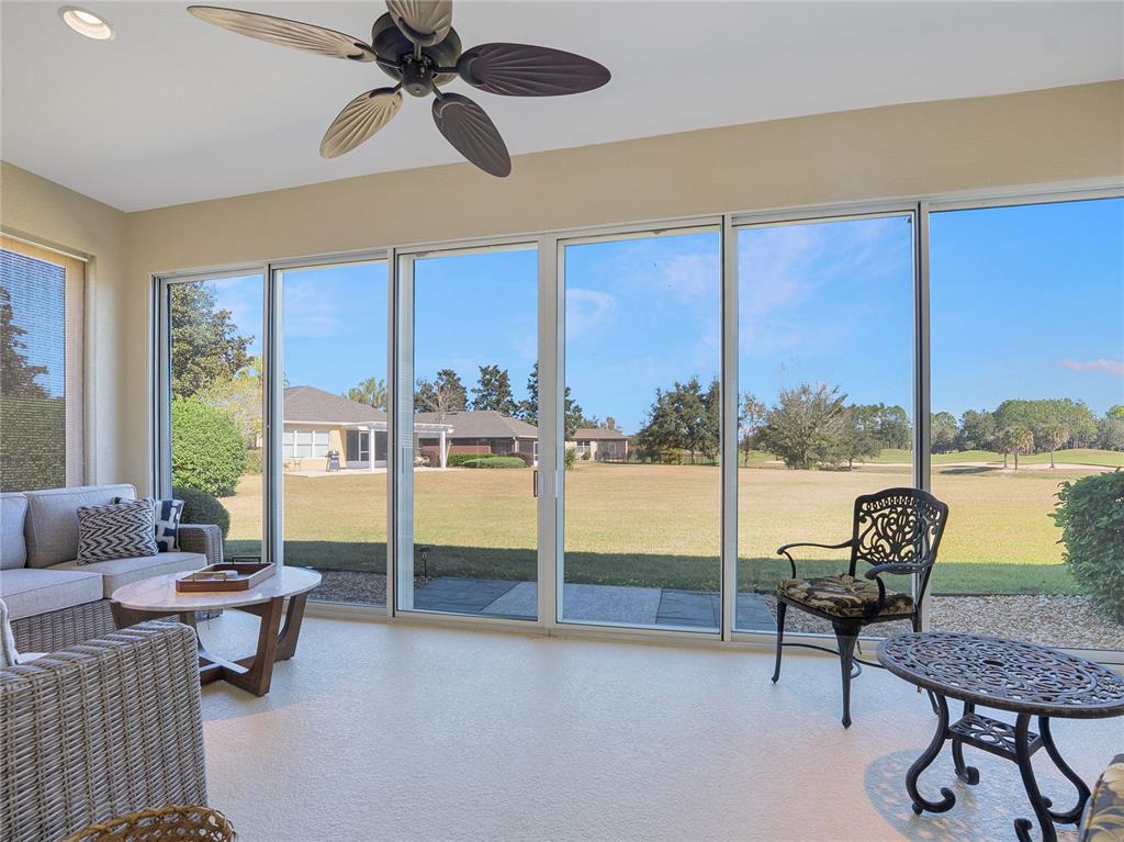 6776 Southwest 91st Circle Ocala, FL 34481 - Photo 55 of 60 a living room with furniture and a floor to ceiling window