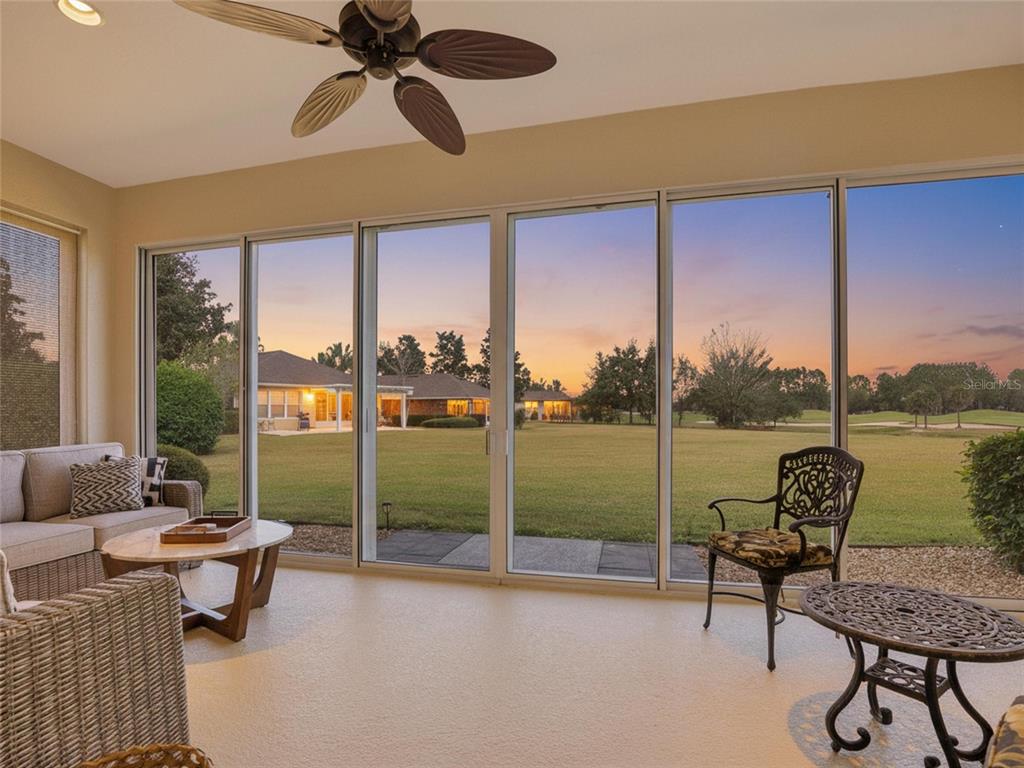 6776 Southwest 91st Circle Ocala, FL 34481 - Photo 58 of 60 a living room with couch and a floor to ceiling window