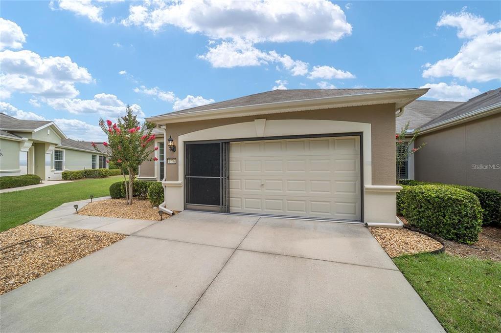 6776 Southwest 91st Circle Ocala, FL 34481 - Photo 10 of 60 a front view of a house with a yard and garage