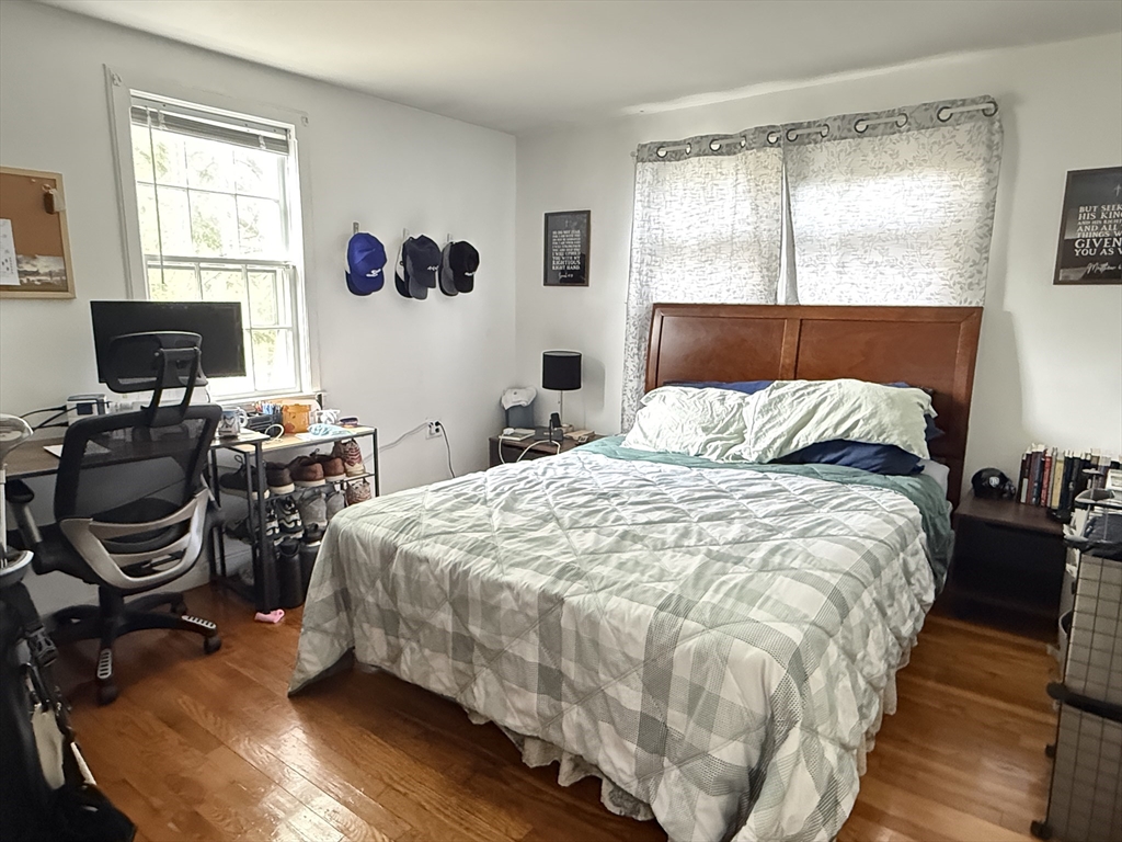 43 Hillcroft Road, Unit 43 Waltham, MA 02452 - Photo 3 of 20 a bedroom with a bed and wooden floor