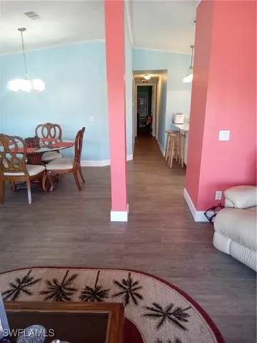 a dining room with furniture and wooden floor