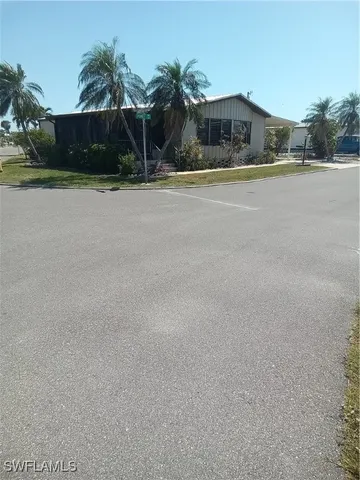 a front view of house with yard and trees