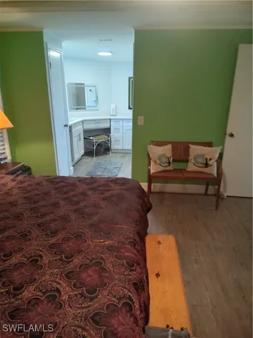 a bedroom with a bed and a view of living room