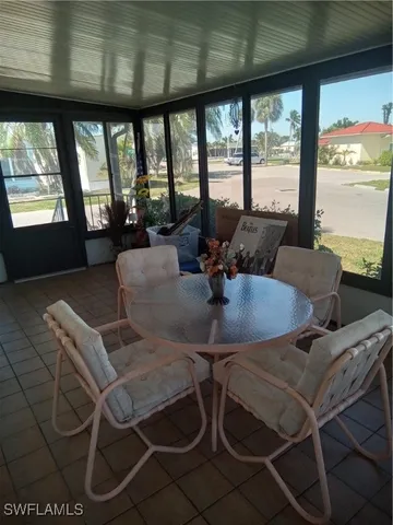 a view of a dining room with furniture large windows and wooden floor
