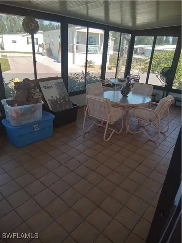 a living room with furniture and a floor to ceiling window