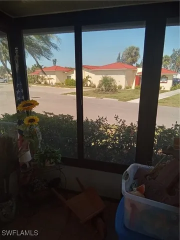 a living room with couches and a floor to ceiling window