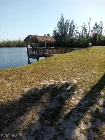a view of a lake with chairs
