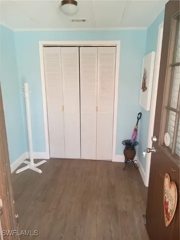 a view of a room with wooden floor and cabinet