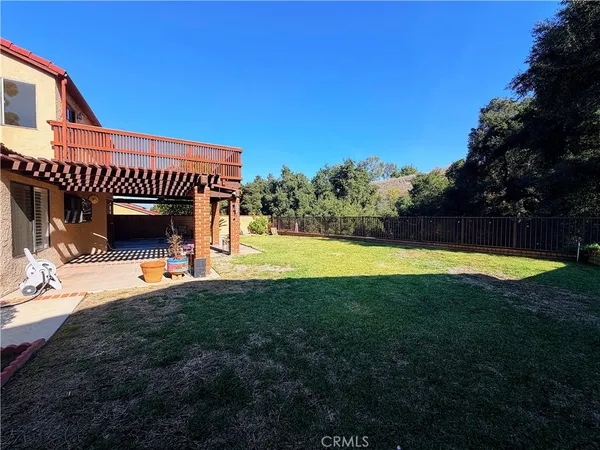 a view of a house with a swimming pool and a yard