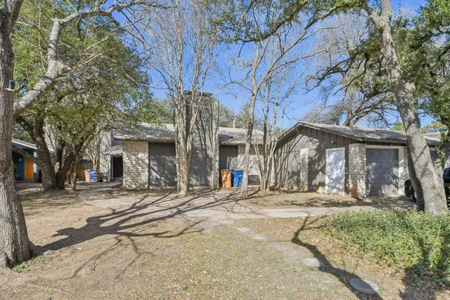 a view of a house with large trees