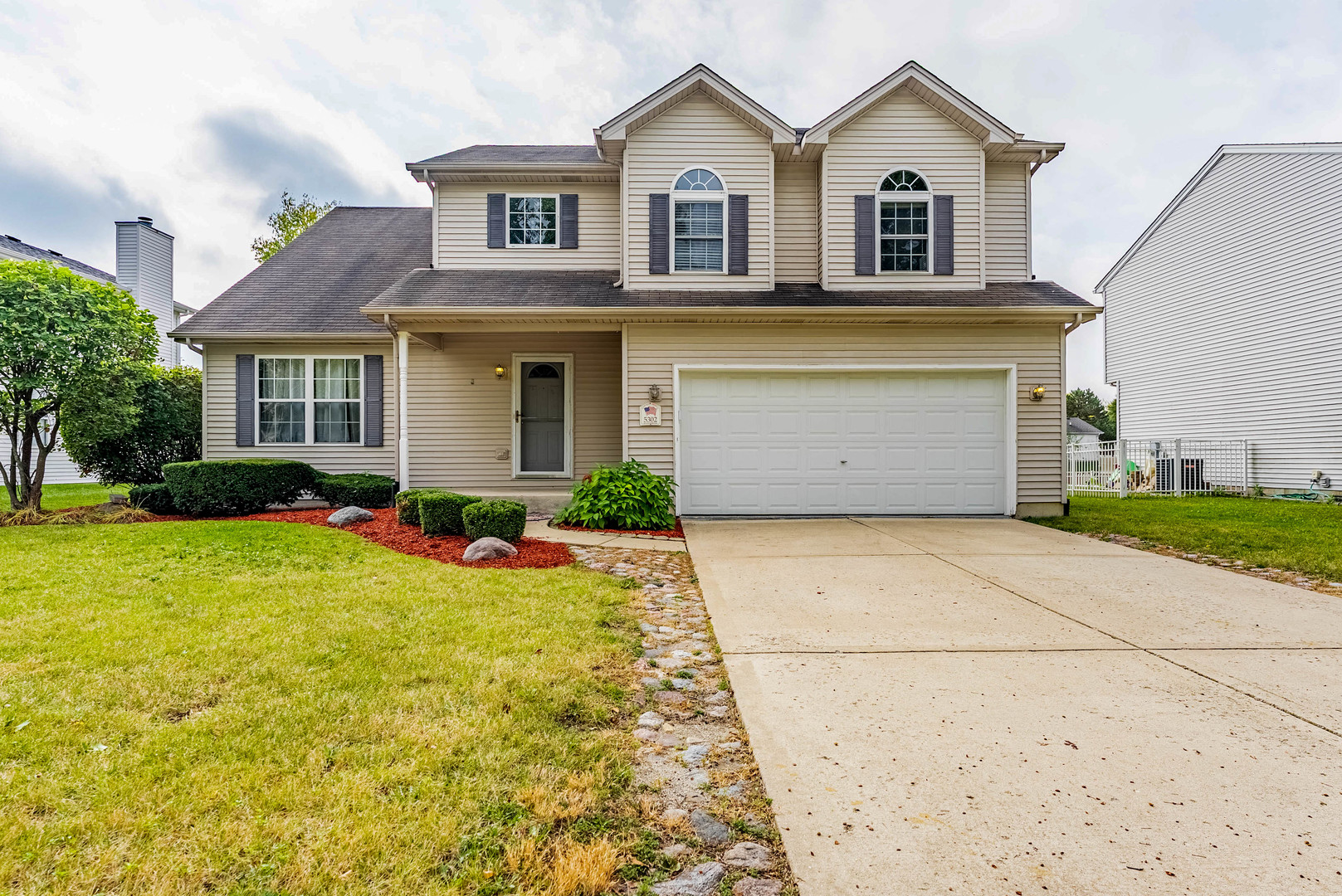 5302 Meadowbrook Street Plainfield, IL 60586 - Photo 1 of 46 a view of a white house with a yard and large tree