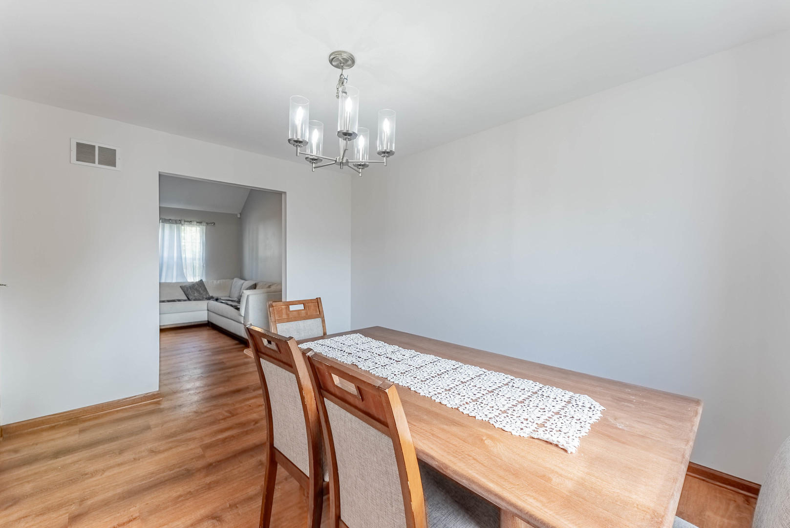 5302 Meadowbrook Street Plainfield, IL 60586 - Photo 11 of 46 a view of a dining room with furniture and wooden floor