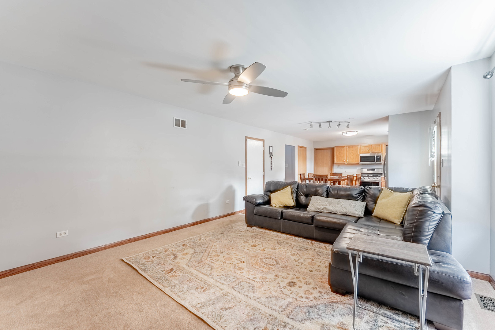 5302 Meadowbrook Street Plainfield, IL 60586 - Photo 16 of 46 a living room with furniture and a ceiling fan