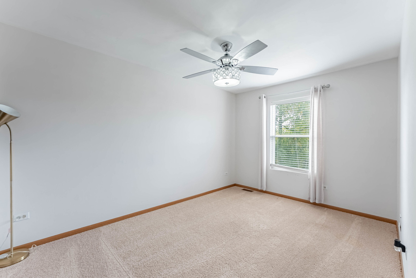 5302 Meadowbrook Street Plainfield, IL 60586 - Photo 19 of 46 an empty room with a window and a fan