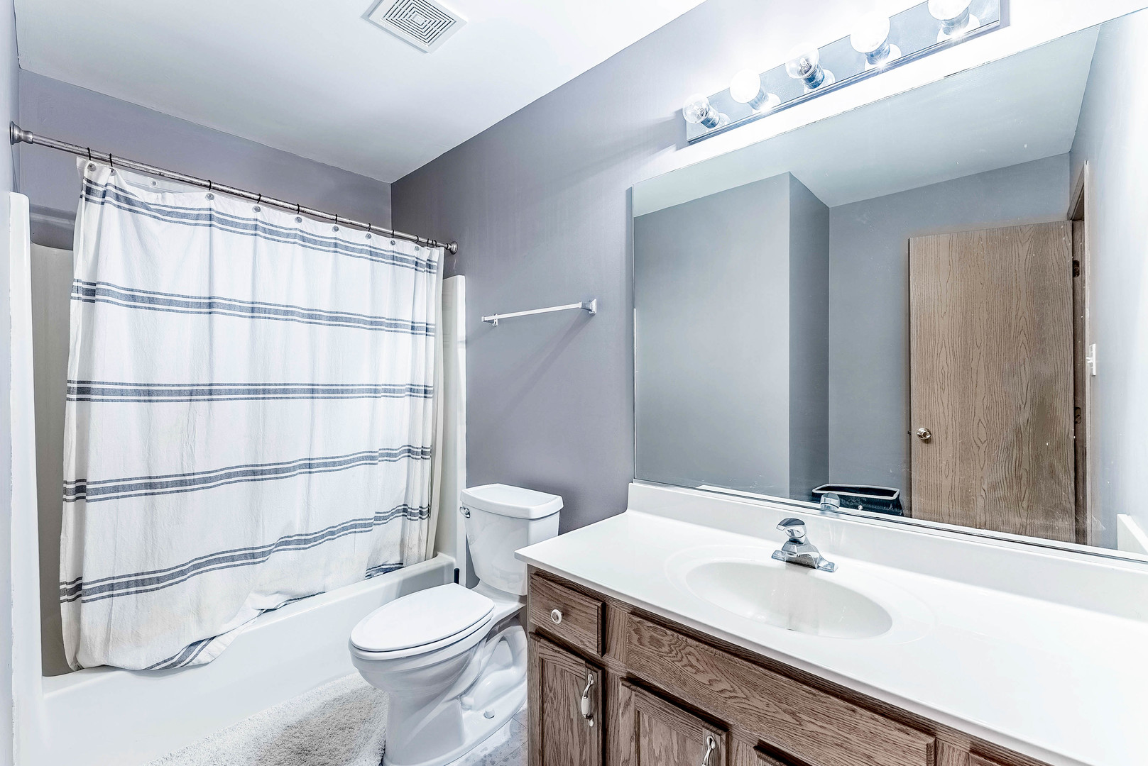 5302 Meadowbrook Street Plainfield, IL 60586 - Photo 22 of 46 a bathroom with a sink a toilet a mirror and shower