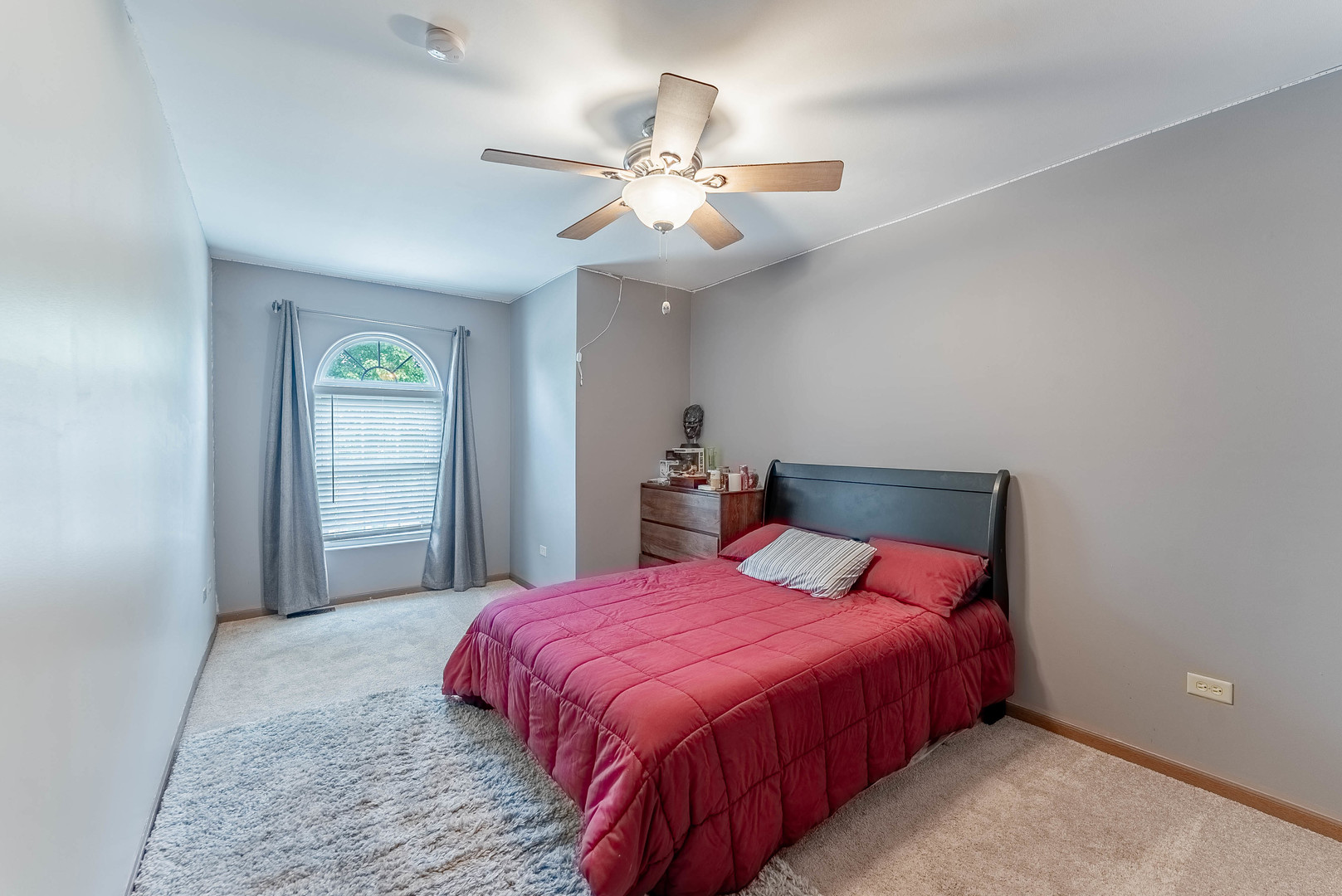 5302 Meadowbrook Street Plainfield, IL 60586 - Photo 23 of 46 a bedroom with a large bed and a chandelier
