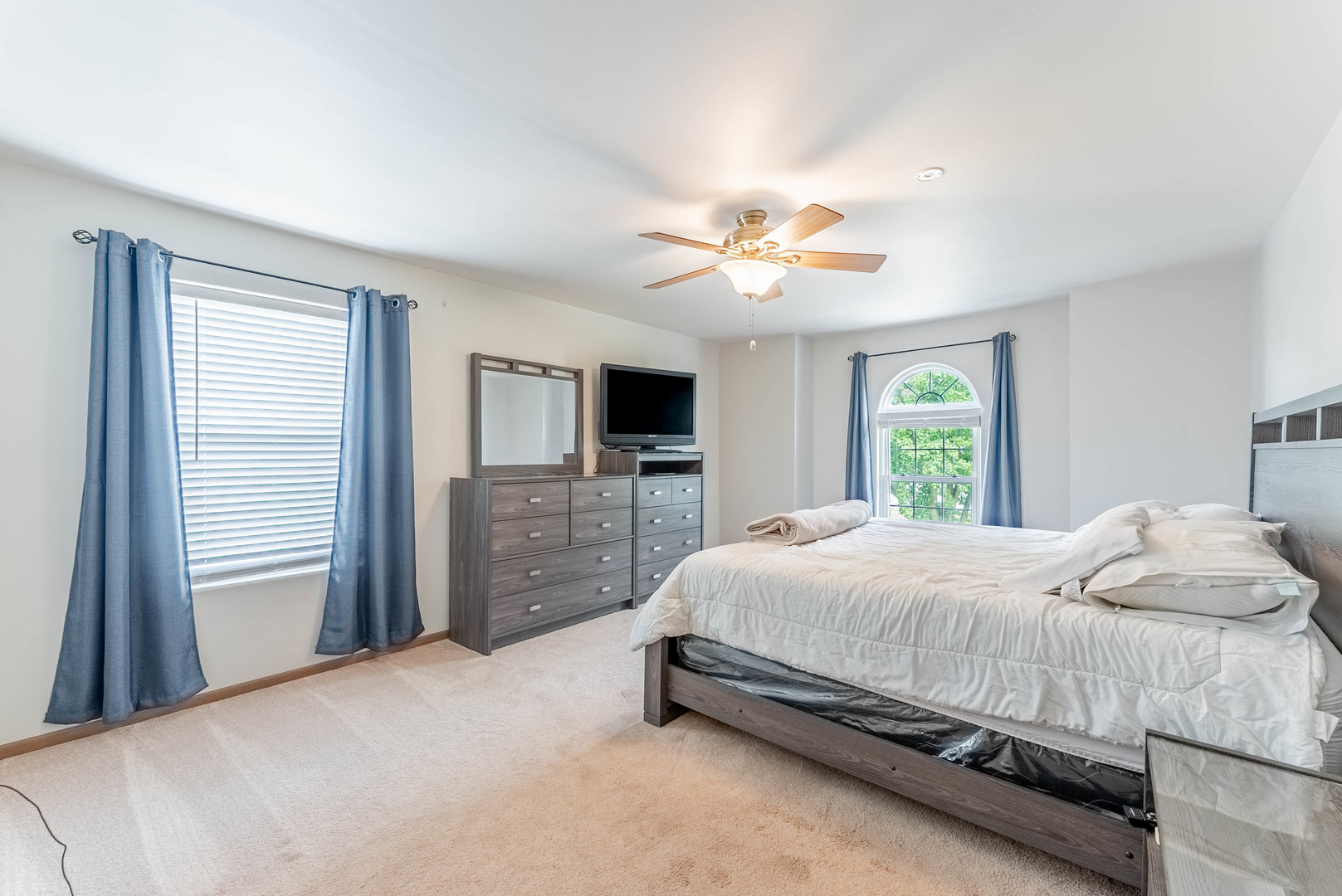 5302 Meadowbrook Street Plainfield, IL 60586 - Photo 26 of 46 a bedroom with a large bed and a tv