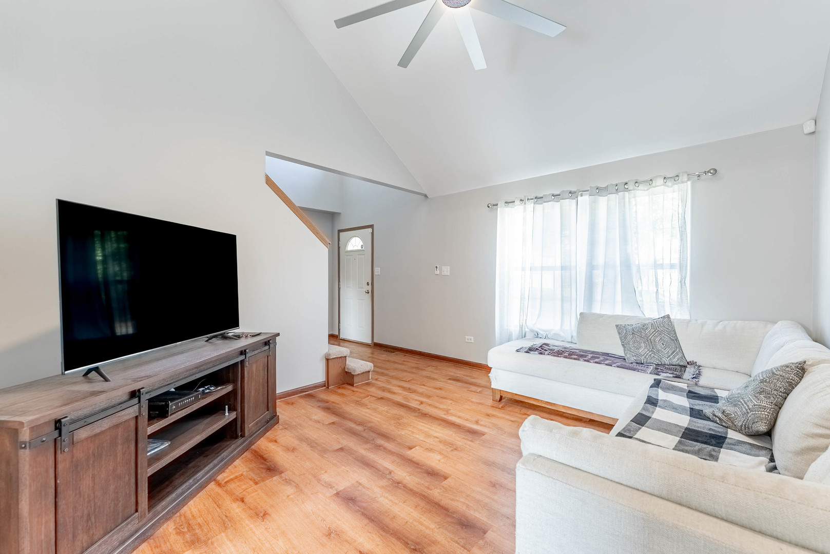 5302 Meadowbrook Street Plainfield, IL 60586 - Photo 7 of 46 a living room with furniture and a flat screen tv