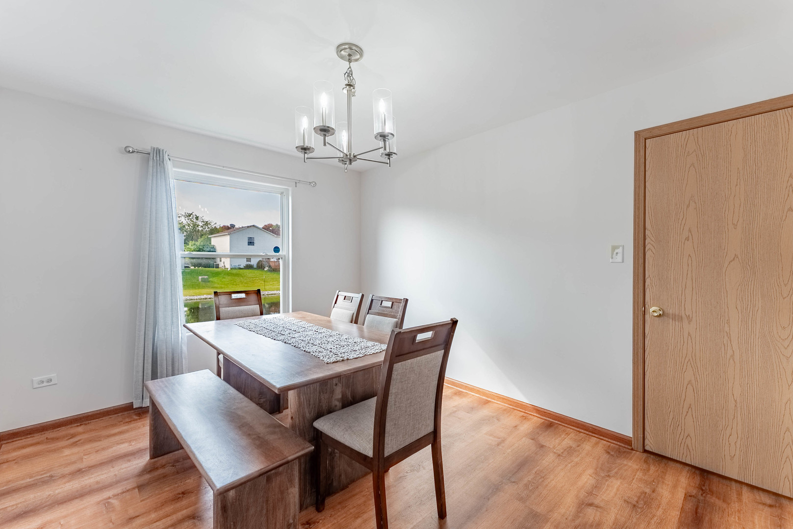 5302 Meadowbrook Street Plainfield, IL 60586 - Photo 10 of 46 a view of a dining room with furniture and wooden floor