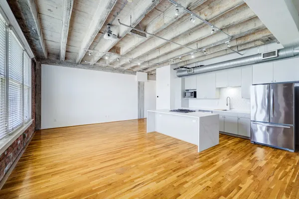 a kitchen with stainless steel appliances granite countertop a refrigerator and a sink