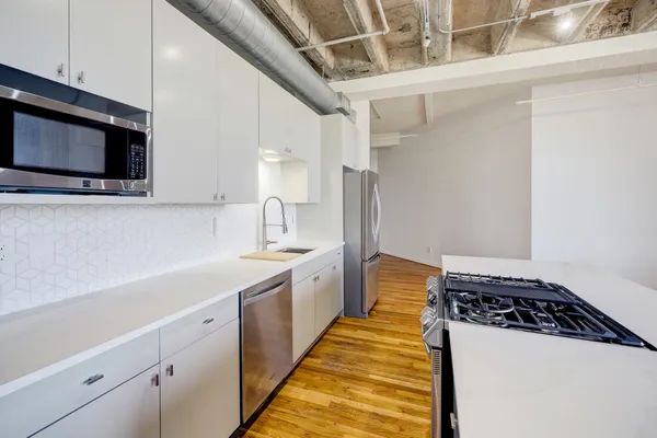 a kitchen with stainless steel appliances a sink and a microwave