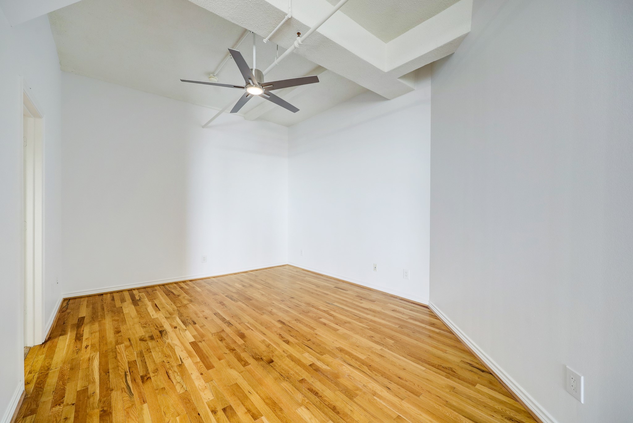 201 Main Street, Unit 6D Houston, TX 77002 - Photo 4 of 24 a view of a big room with wooden floor