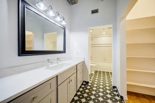 a bathroom with a double vanity sink mirror and double