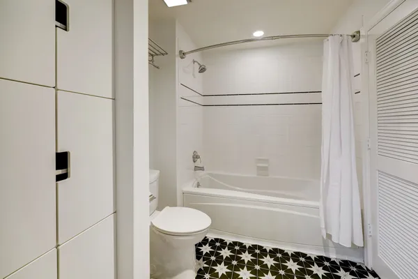a bathroom with a bathtub and a shower
