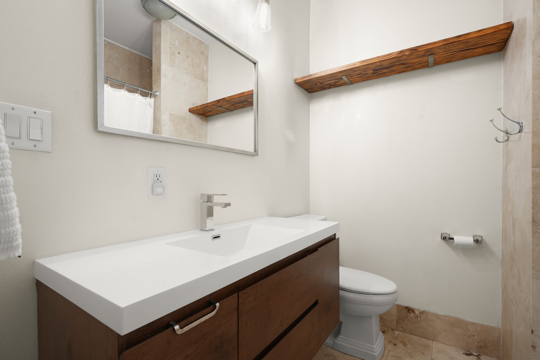 2501 Del Curto Road Austin, TX 78704 - Photo 21 of 26 Clean lines and warm wood accents define this modern bathroom with tile flooring.