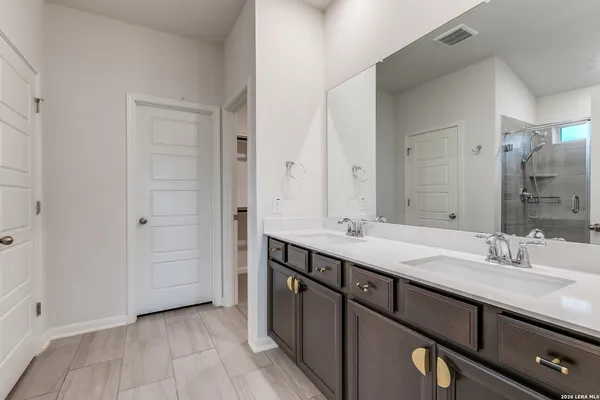 a bathroom with a double vanity sink and mirror