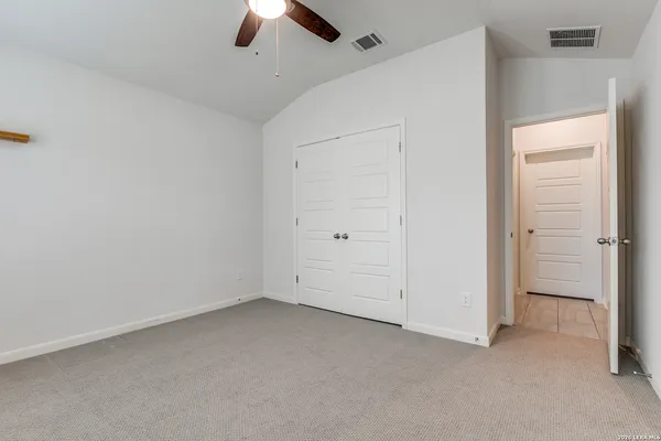 an empty room with ceiling fan