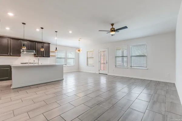 a view of kitchen with windows and refrigerator